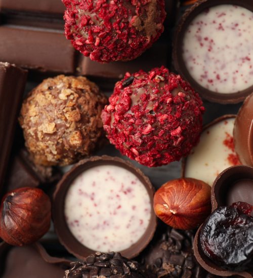 Tasty chocolate candies all over background, close up